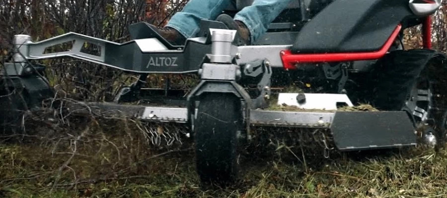 Close-up of Altoz 766 mower cutting deck navigating through brush